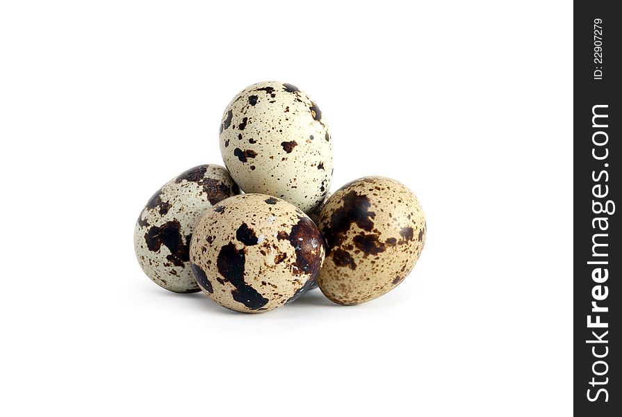 Small heap of quail eggs on white background. Isolated with clipping path