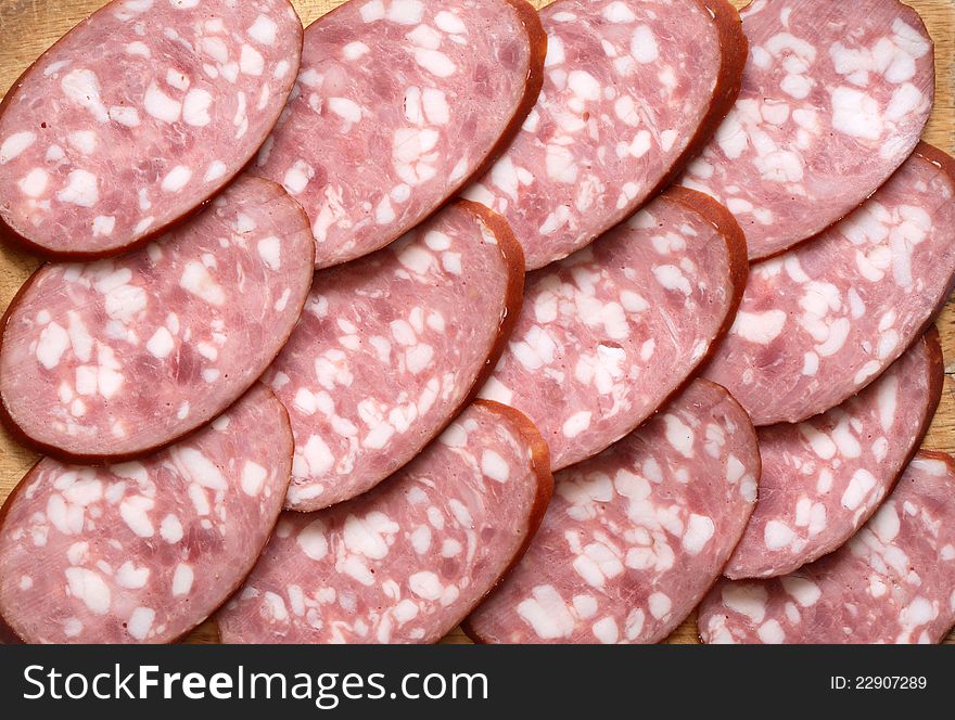 Background made from lot of sliced salami. Extreme closeup. Background made from lot of sliced salami. Extreme closeup