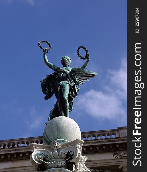 Bronze statue of a winged victory brandishing laurel wreathes. Bronze statue of a winged victory brandishing laurel wreathes