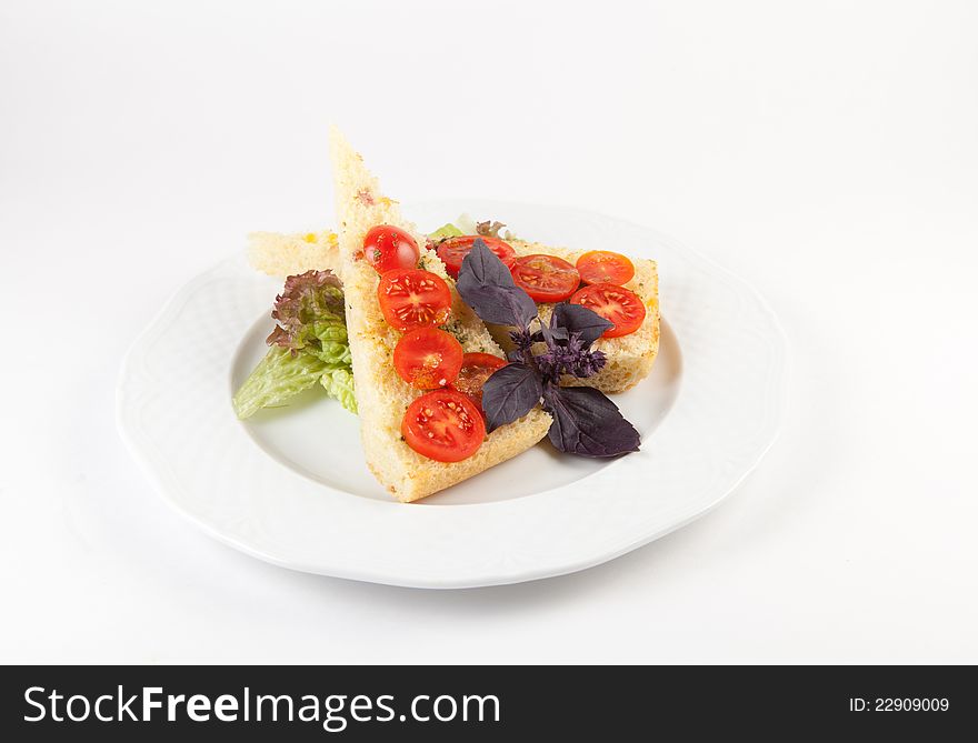 Traditional italian bread bruchetta on a plate with tomatoes