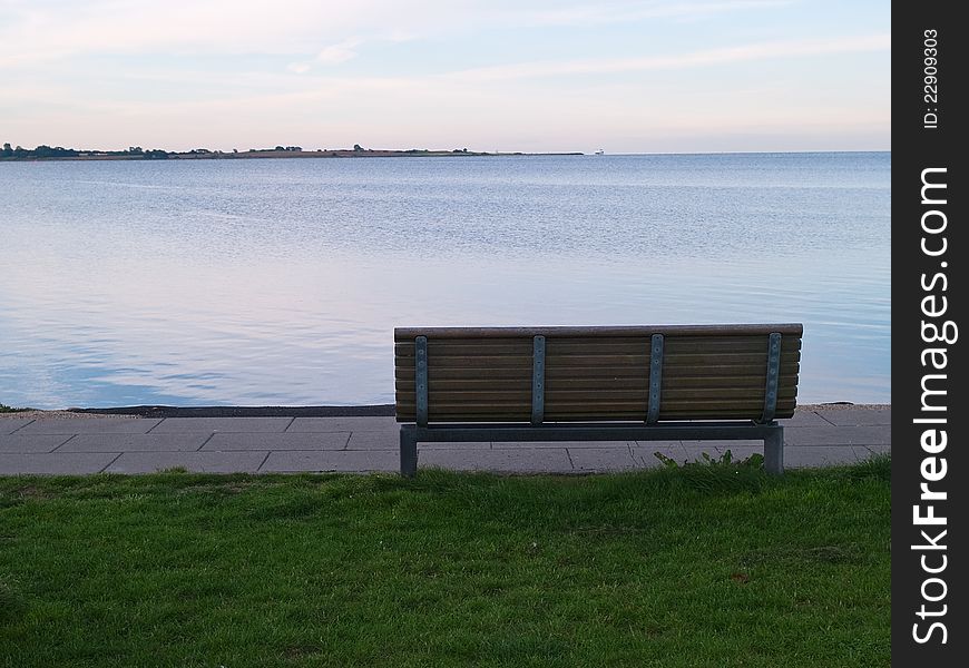 Single Wooden Bench In Front Of The Sea