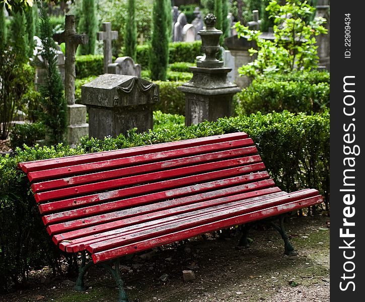 Red bench at English Cemetery in Lisbon, Portugal.