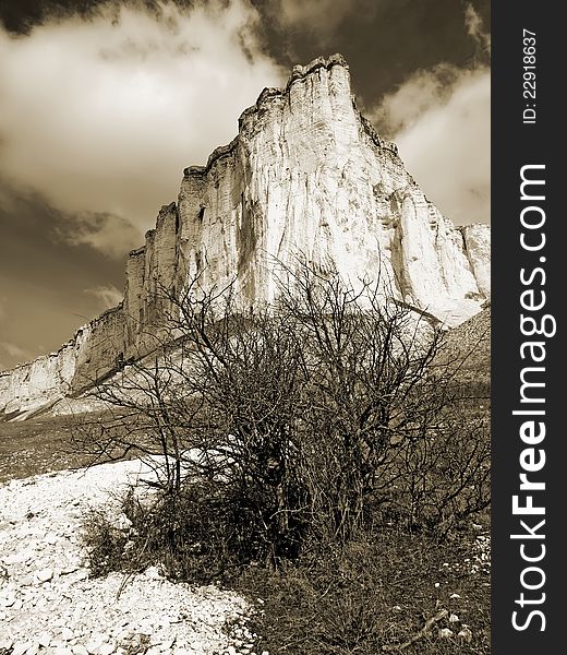 Rock \Belaja skala\ and a cloudy sky near Belogorsk, Crimea, Ukraine. Sepia image