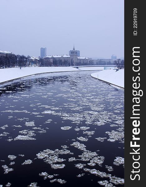 Ice in a river Neris in town Vilnius, Lithuania, vertical. Ice in a river Neris in town Vilnius, Lithuania, vertical