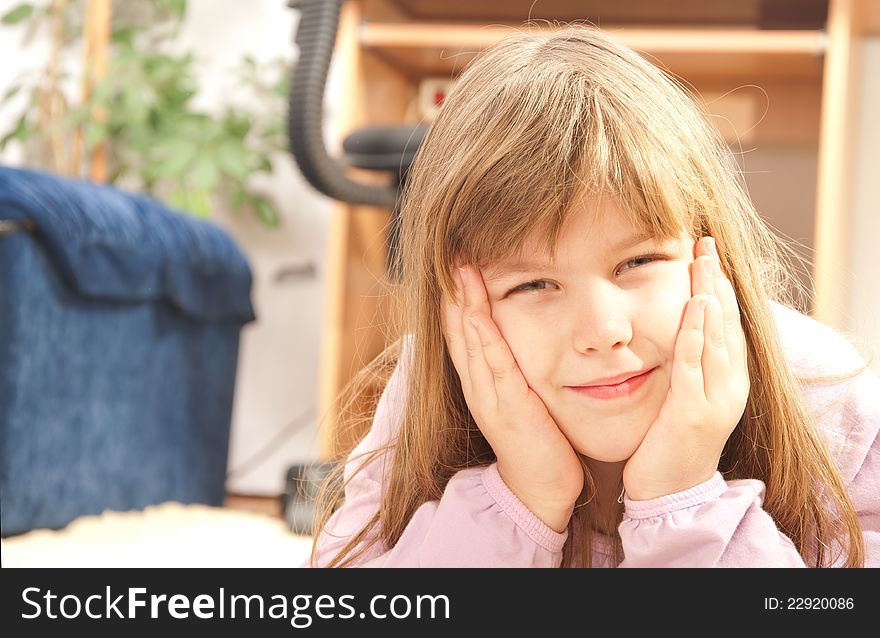 Happy little girl lying on the floor in her room. Happy little girl lying on the floor in her room