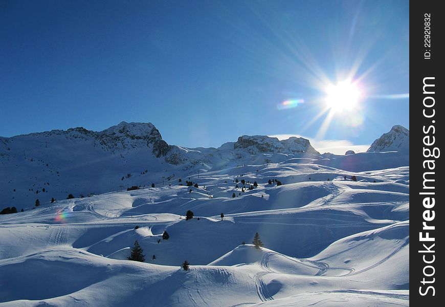 A snow covered alpine rocky mountain. A snow covered alpine rocky mountain