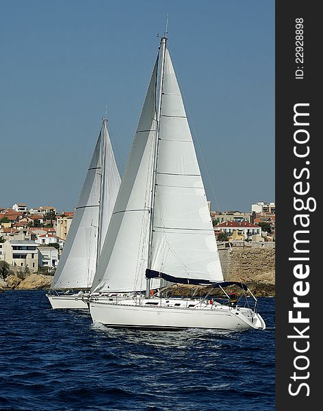 Sailboats attending a regatta alongside the french coast. Sailboats attending a regatta alongside the french coast.