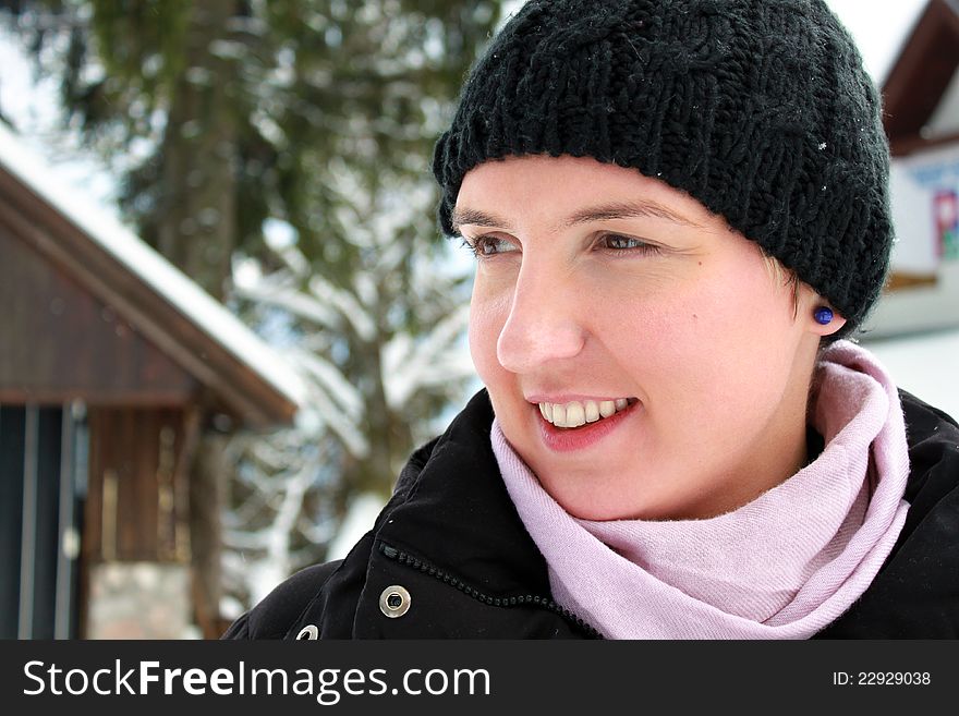 Happy young woman smiling, spending her winter holiday in a mountain cabin. Happy young woman smiling, spending her winter holiday in a mountain cabin