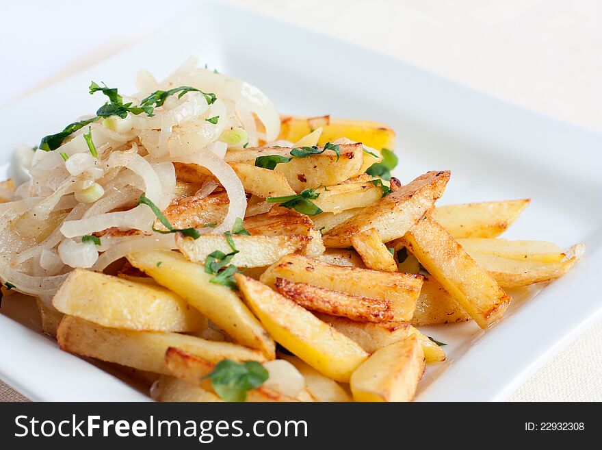 Tasty fried potatoes with onions