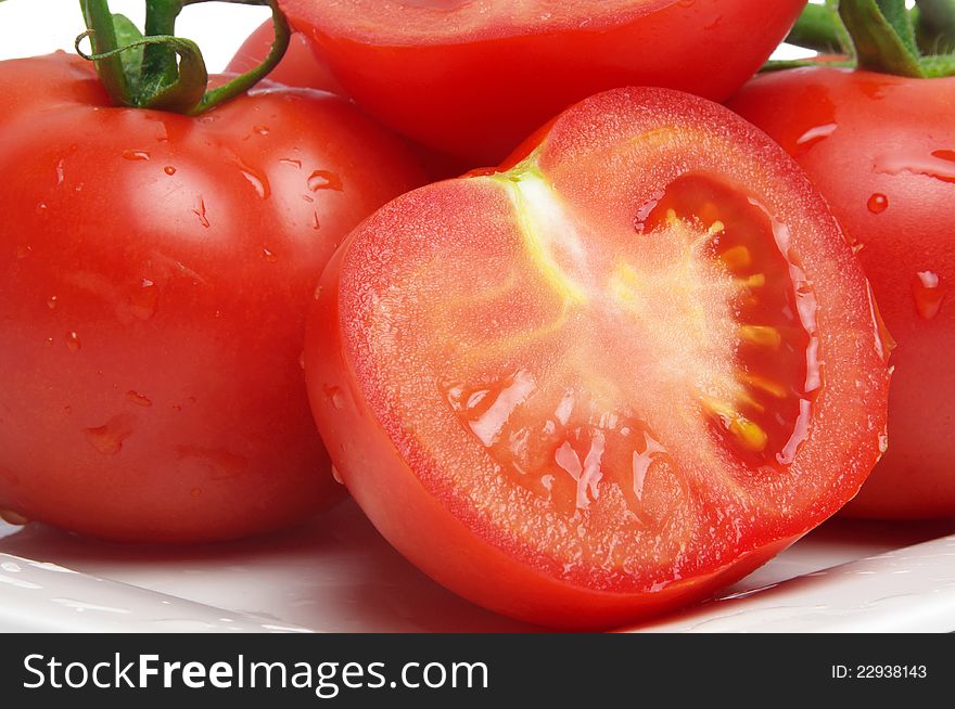 Wet tomatoes closeup on plate