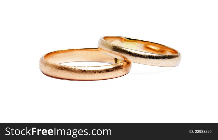 Two worn golden rings on white. Two worn golden rings on white