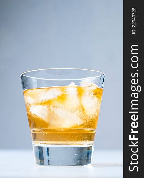 A glass of cold drink with ice