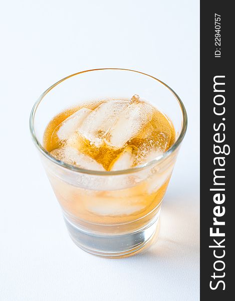 A glass of cold drink with ice
