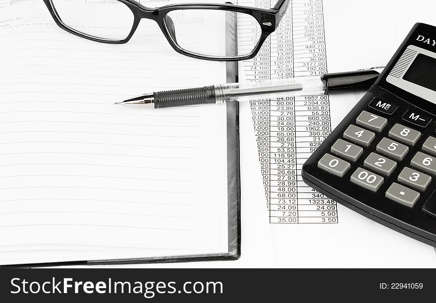 Calculator and pen on a business background