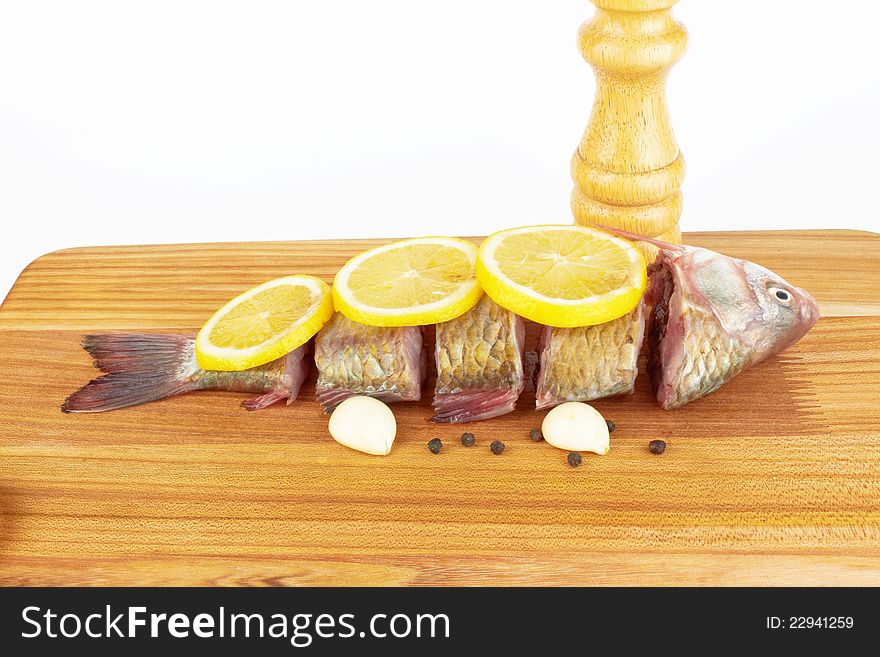 Raw fish with cooking ingredients on a cutting board