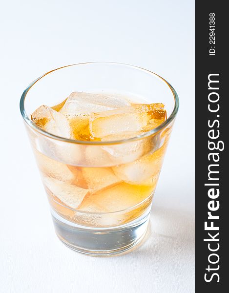 A glass of cold drink with ice