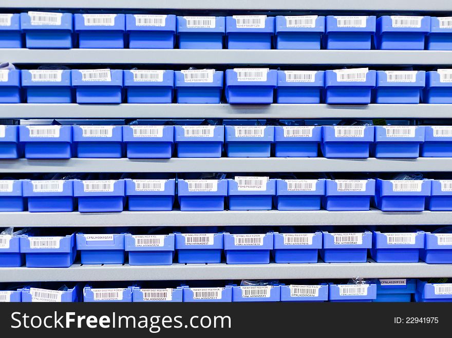 Blue plastic boxes in storage stand