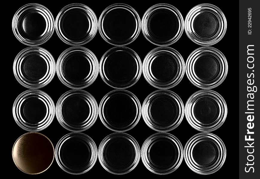 Bottoms of cans on a black background.