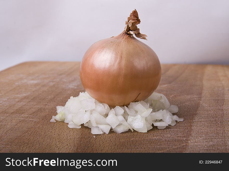 Fresh onion  on a wooden cutting board