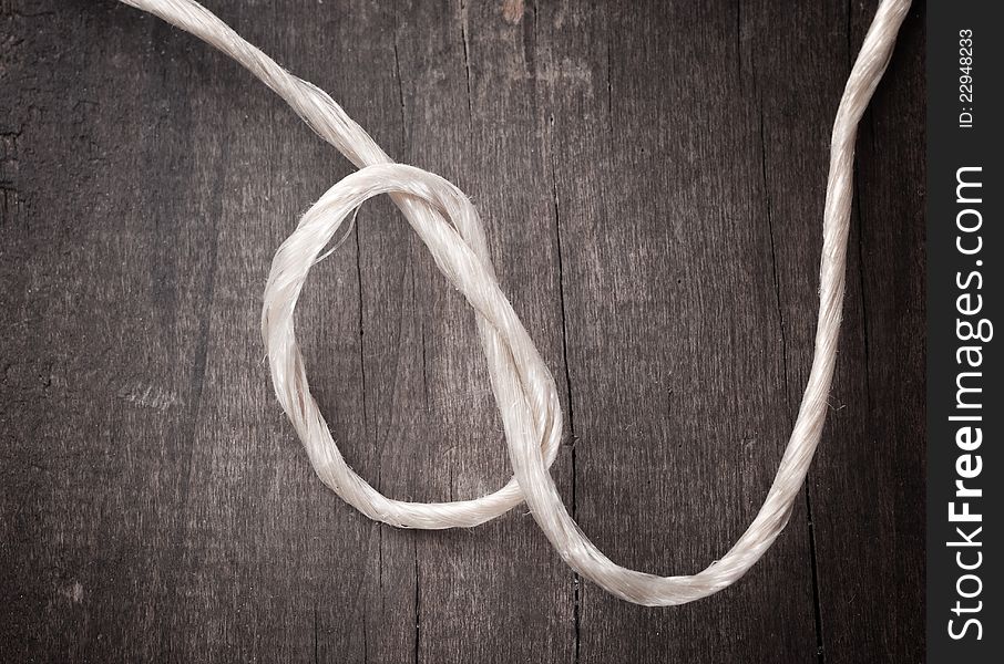 Close up of rope on wooden plank. Close up of rope on wooden plank