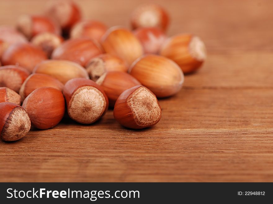 Photo of some filbert nuts over wooden background. Photo of some filbert nuts over wooden background