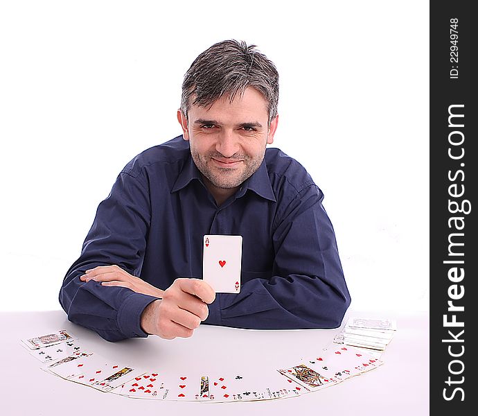 Card player sitting at the table with cards in hand