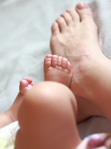 Mother Foot Near The Small Baby Foot Royalty Free Stock Image