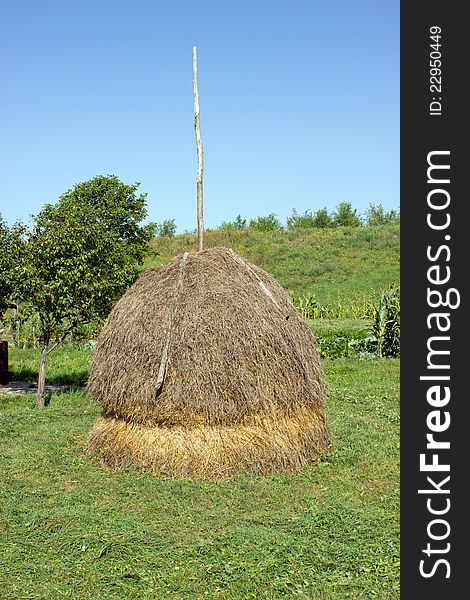 Haystack near the garden with vegetables