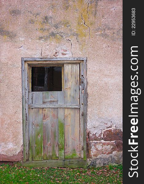 An old weathered gray wooden barn door