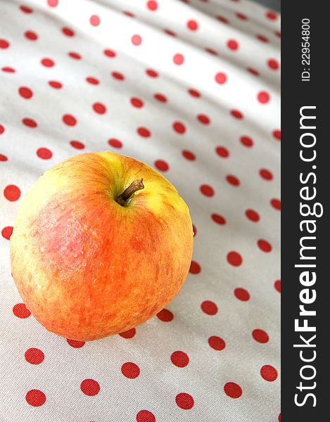 Apple put on polka dots background