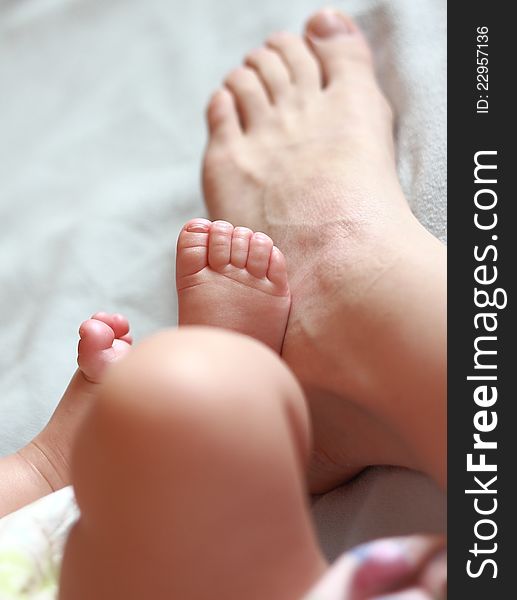 Mother foot near the small baby foot