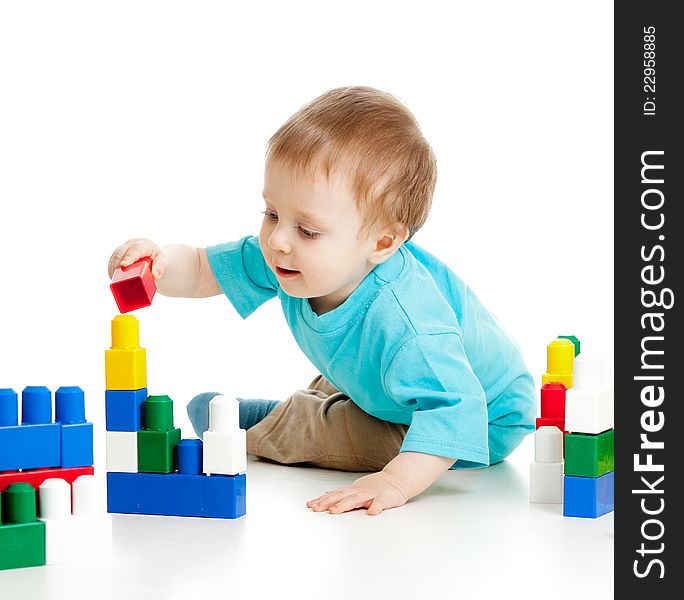 Little cheerful child with construction set over white background