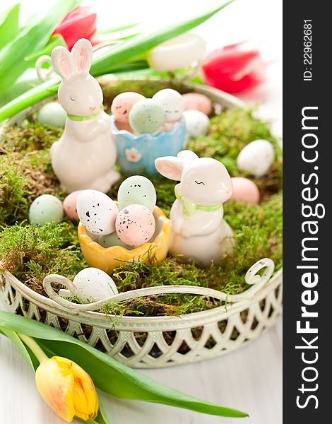 Easter decoration with bunny and chocolate eggs on moss. Easter decoration with bunny and chocolate eggs on moss