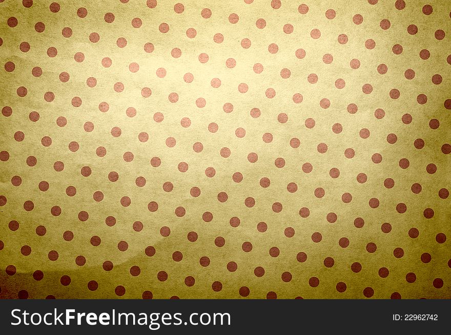 It is a texture of an old paper in red specks. A background in style of a retro