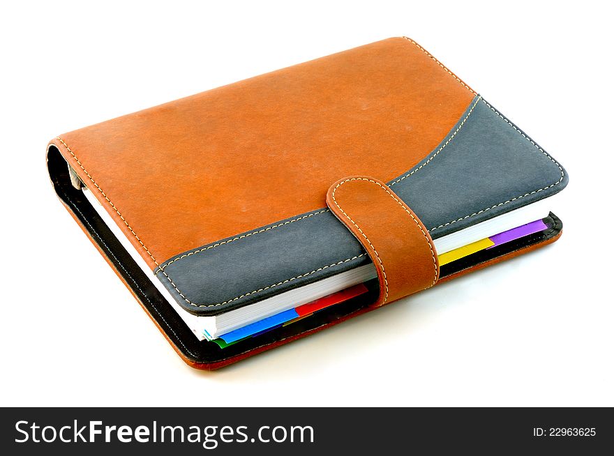 Notebook with a suede cover is brown in color against a white background. Notebook with a suede cover is brown in color against a white background