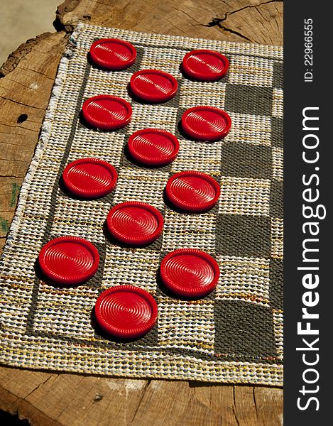 Half of this checker game was spread on an old log. Half of this checker game was spread on an old log.