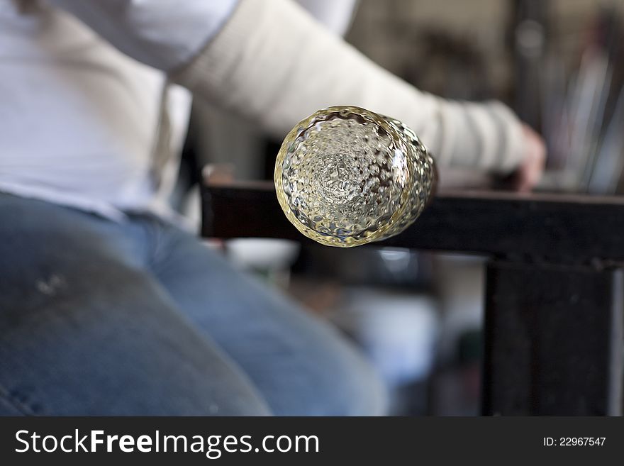 Glassblower shaping molten glass