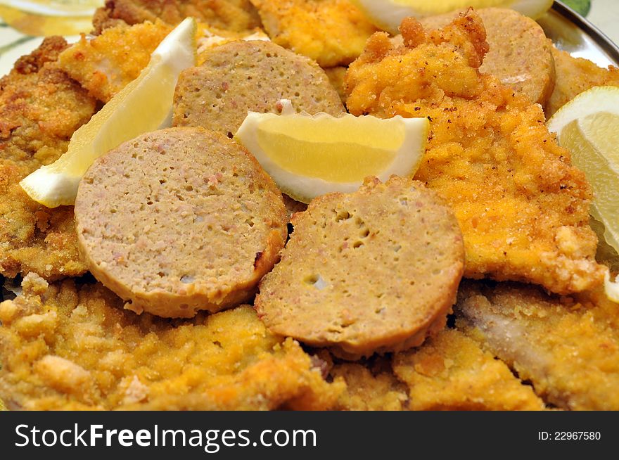 Meatloaf slices and chicken cutlets with lemon. Meatloaf slices and chicken cutlets with lemon