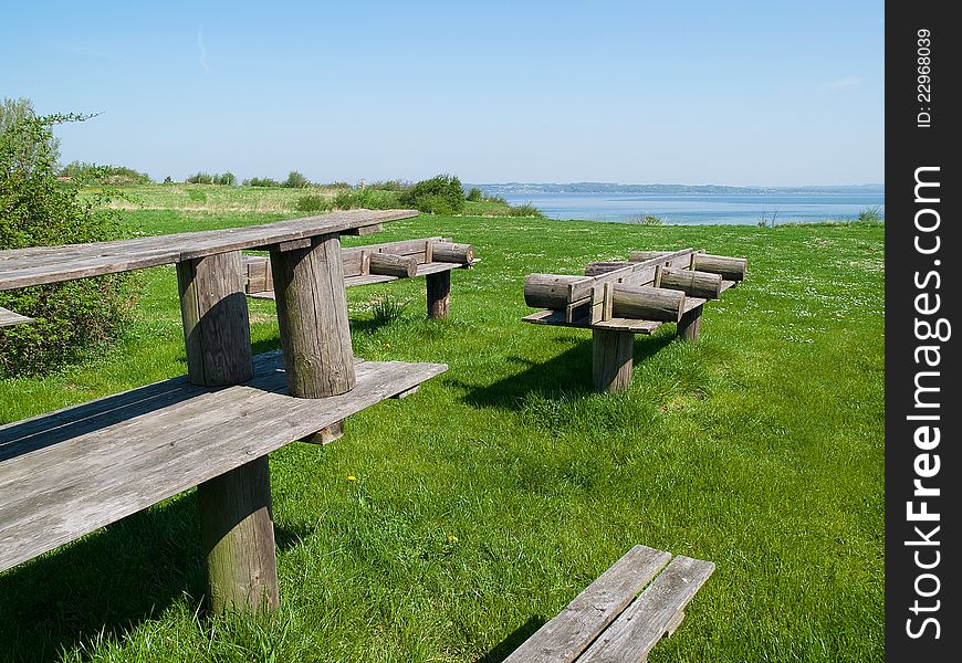 Perfect outdoors picnic setting with wooden tables. Perfect outdoors picnic setting with wooden tables