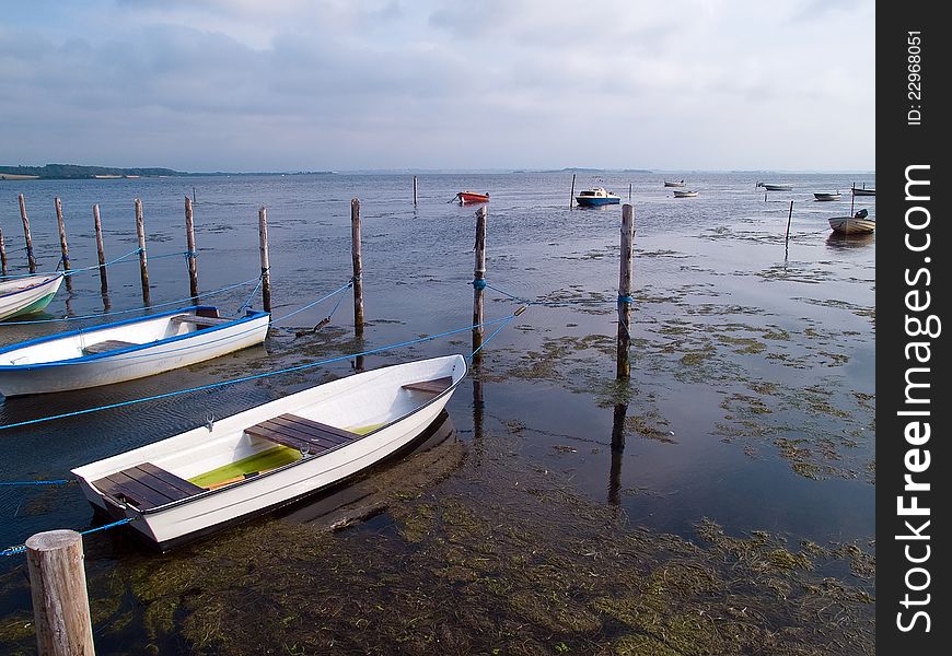 Small dinghy doryfishing boats moored in traditional small marina Denmark. Small dinghy doryfishing boats moored in traditional small marina Denmark