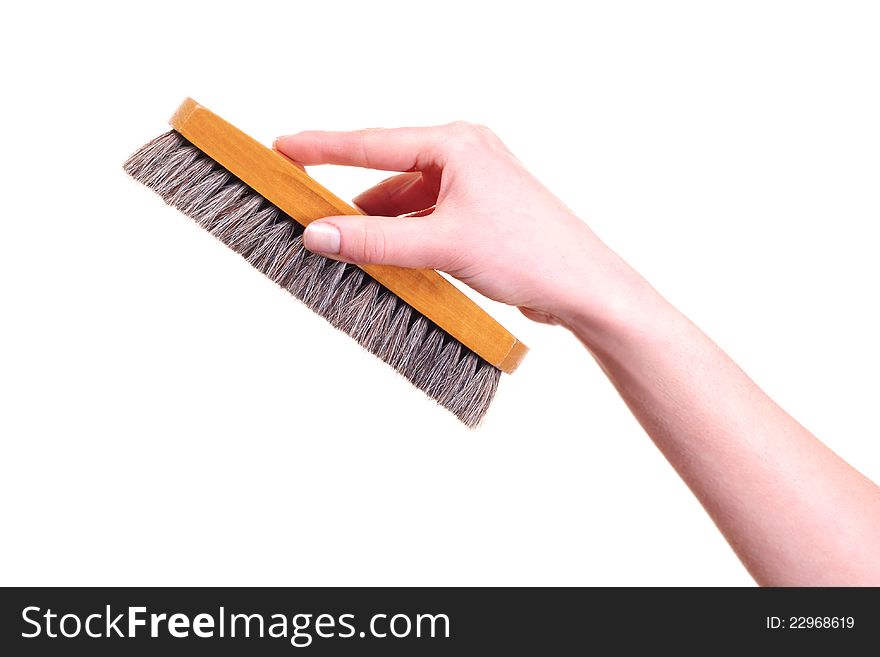 Bristle brush in the hand isolated on white background