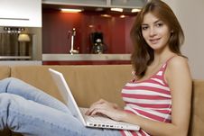 Young Woman Lying On A White Sofa With A Laptop. Stock Photos Young Woman Lying On A White Sofa With A Laptop. Stock Photos