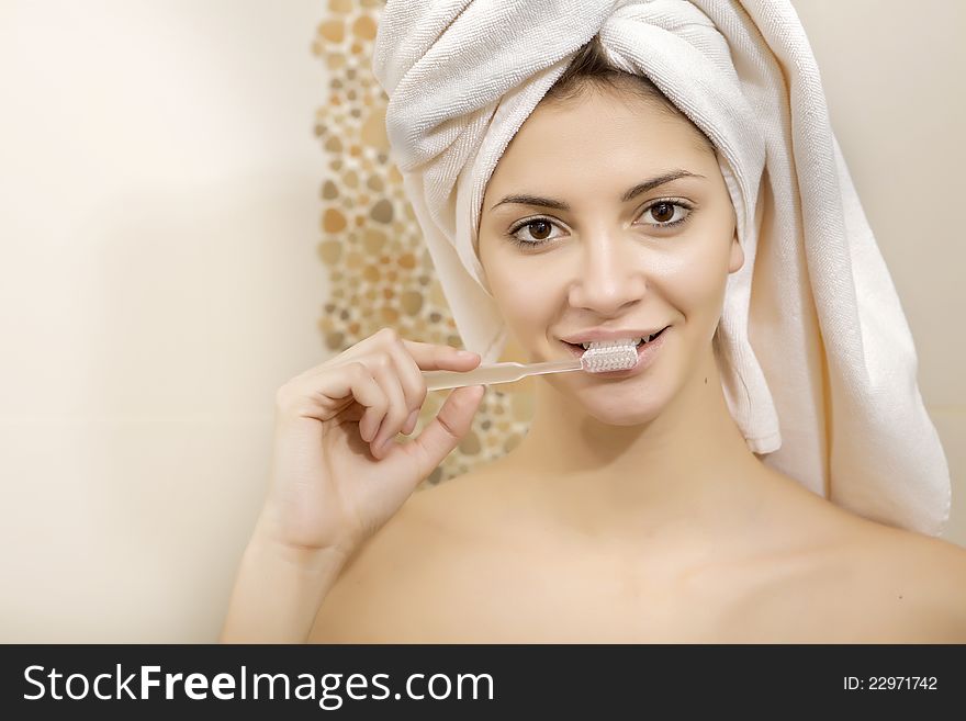 Portrait of a young beautiful brunette woman brushing her teeth. Portrait of a young beautiful brunette woman brushing her teeth