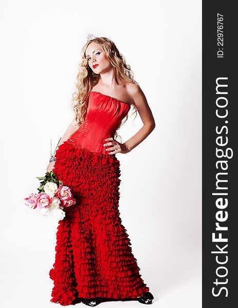 Beautiful girl with roses in their hands in a red dress. Beautiful girl with roses in their hands in a red dress