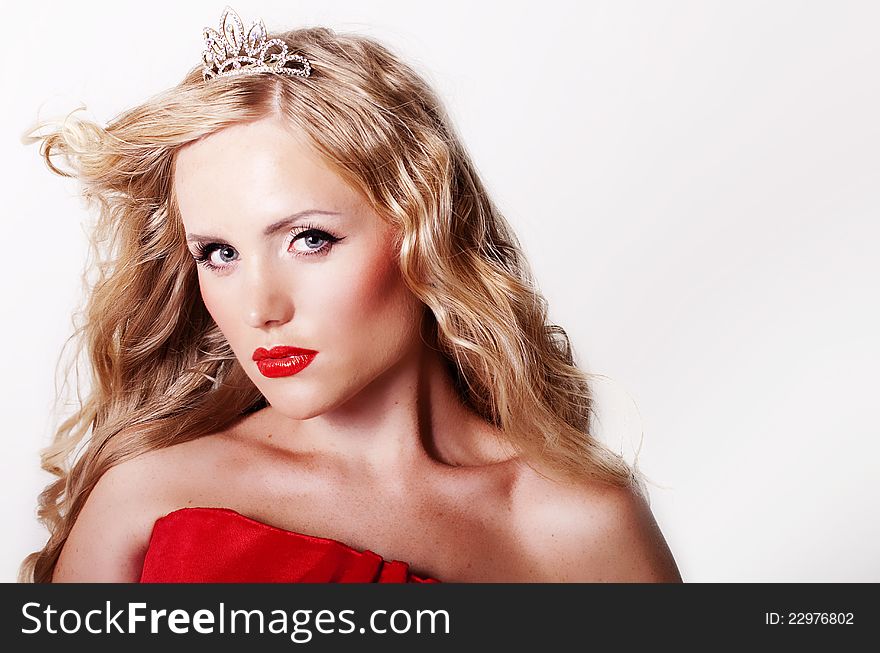 Beautiful girl in a red dress and a crown. Beautiful girl in a red dress and a crown