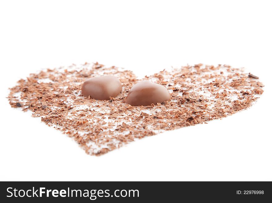 Chocolate hearts and chips on a white background.