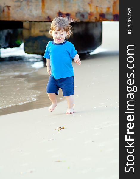 Little boy running on the beach of sea. Little boy running on the beach of sea