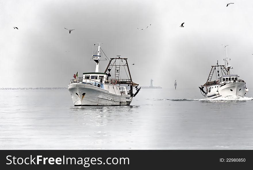 Two fishing boats in the fog