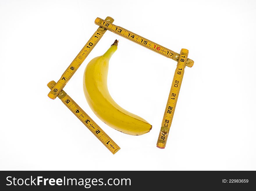 This bannana is getting measured with a ruler. This bannana is getting measured with a ruler