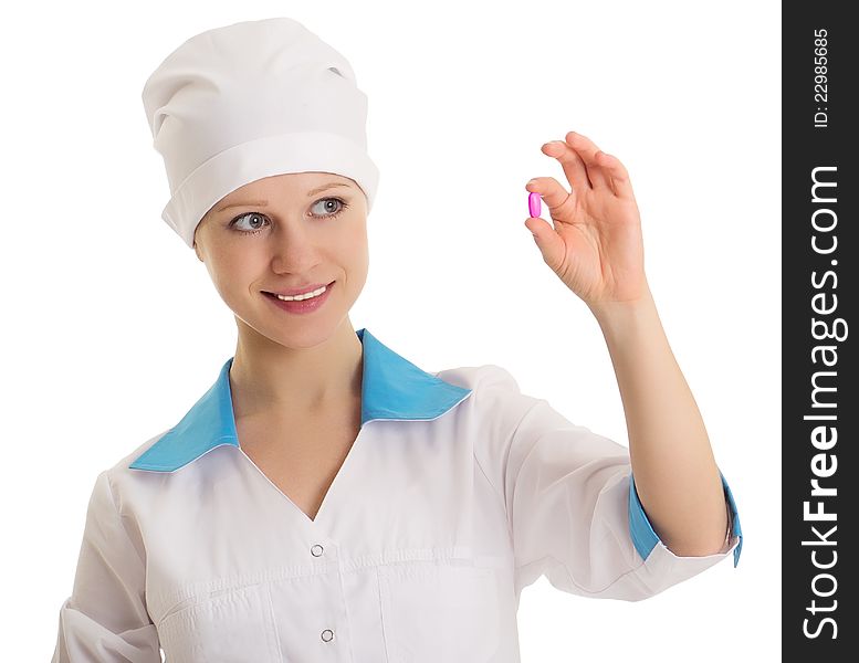 Beautiful nurse holding a pill isolated on white background